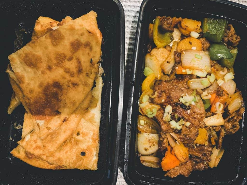 scallion pancake and cumin lamb in takeout boxes