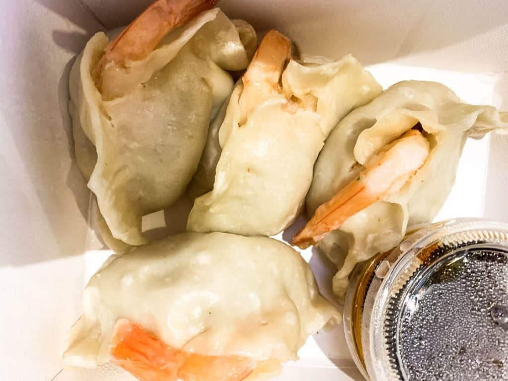 turkey and shrimp dumplings in a takeout container
