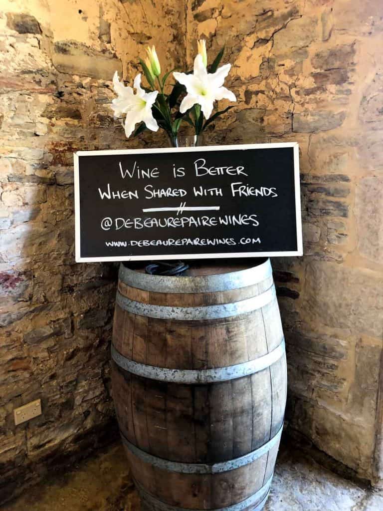 Wine is better when shared with Friends sign on top of a wine barrel