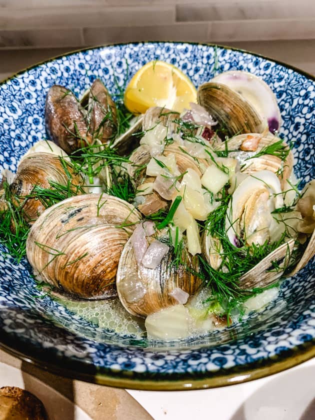 manila clams with fennel and lemon wedge