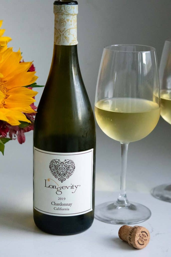 a glass and bottle of 2019 Longevity Chardonnay