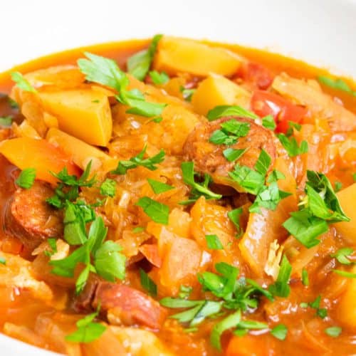 Slovakian Sauerkraut Soup in a white bowl