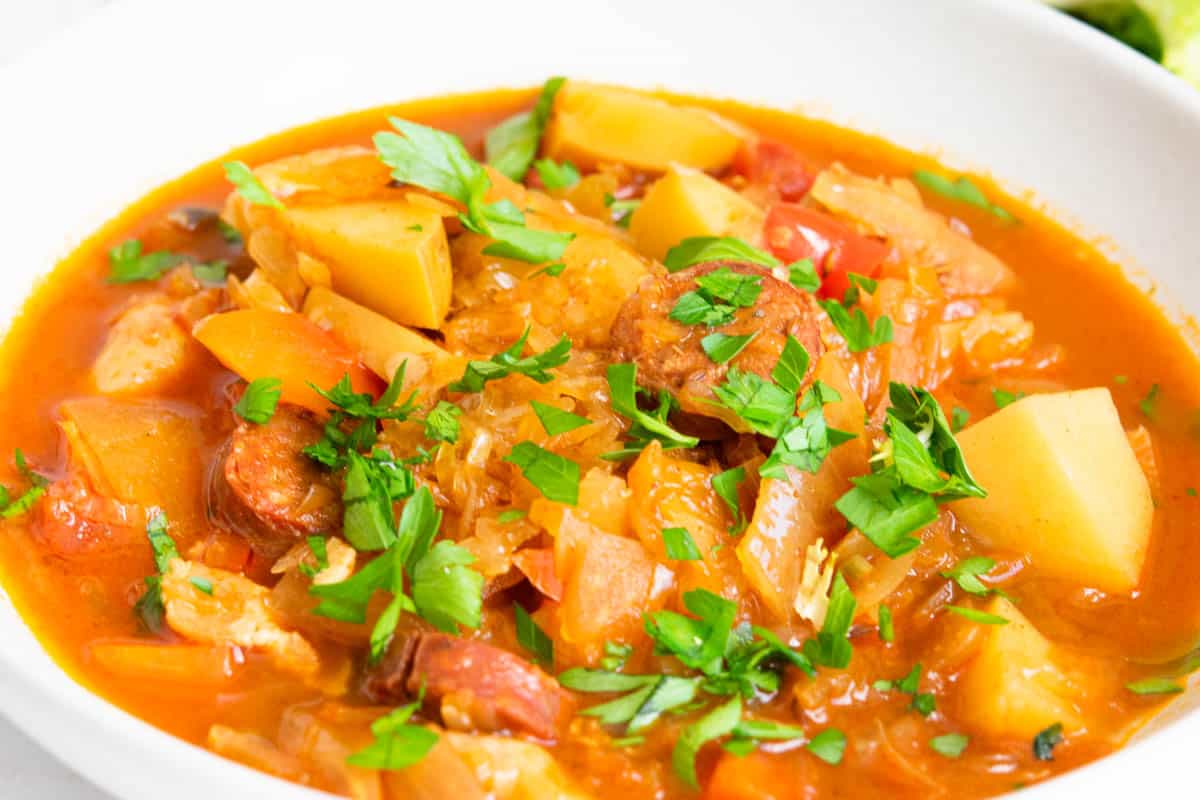 Slovakian Sauerkraut Soup in a white bowl