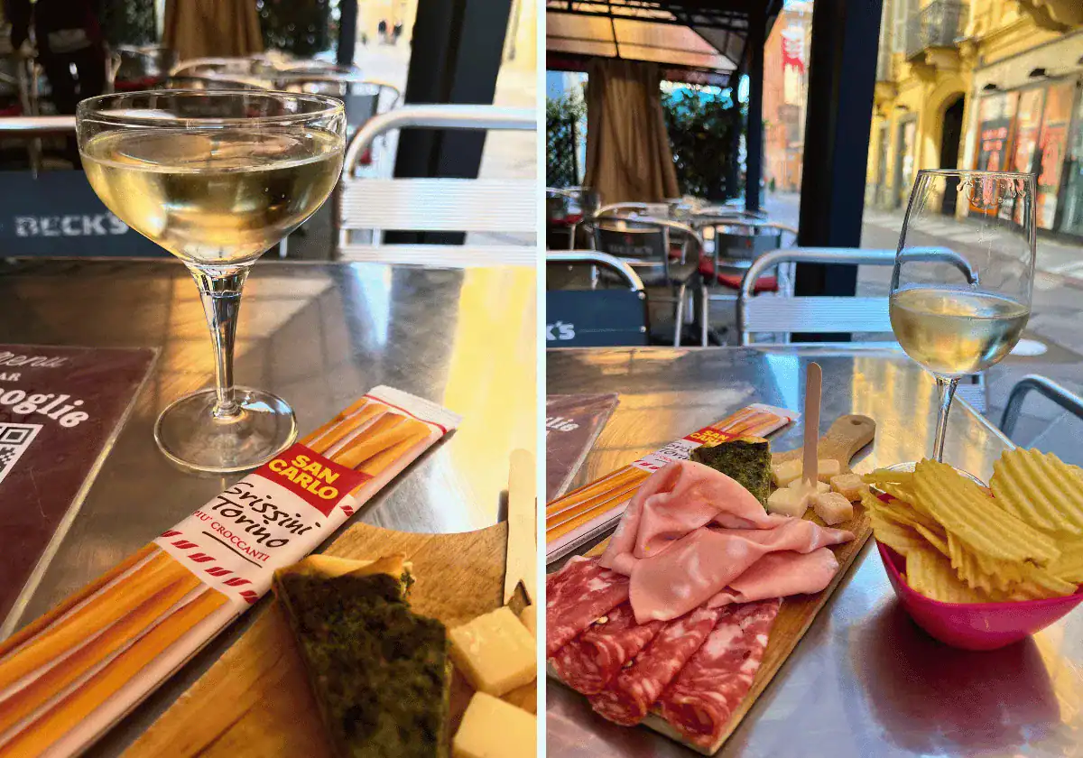 Grissini breadsticks, charctuerie board and potato chips with a glass of prosecco at an outdoor cafe in Italy